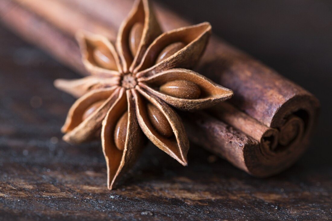 Star anise and cinnamon sticks on a wooden surface