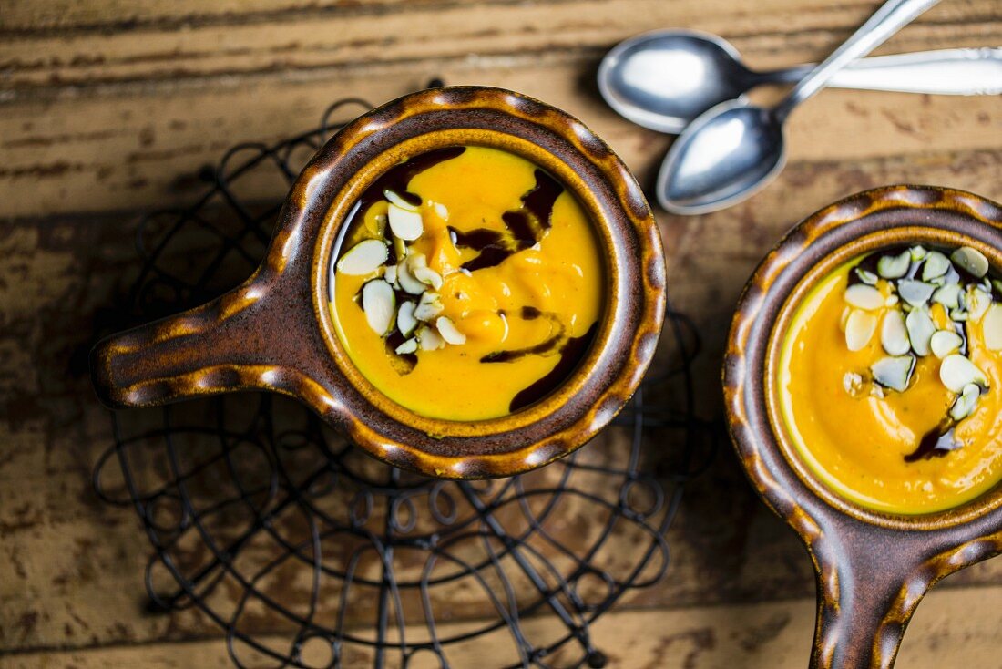 Pumpkin soup with flaked almonds and pumpkin seed oil