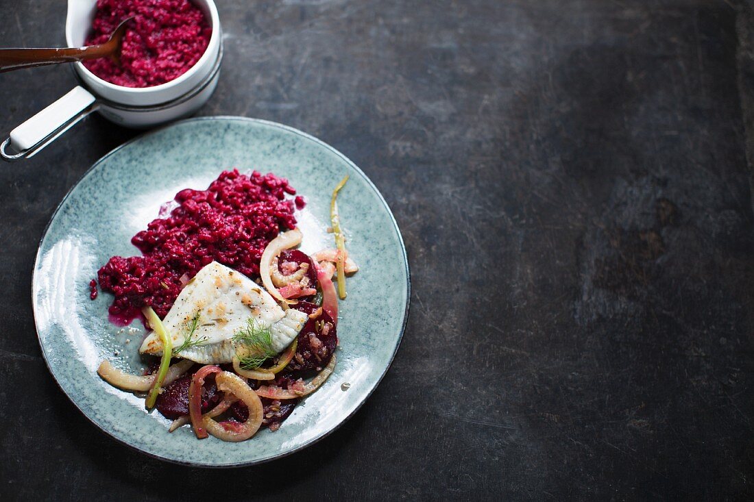 Beetroot risotto with onions and fish