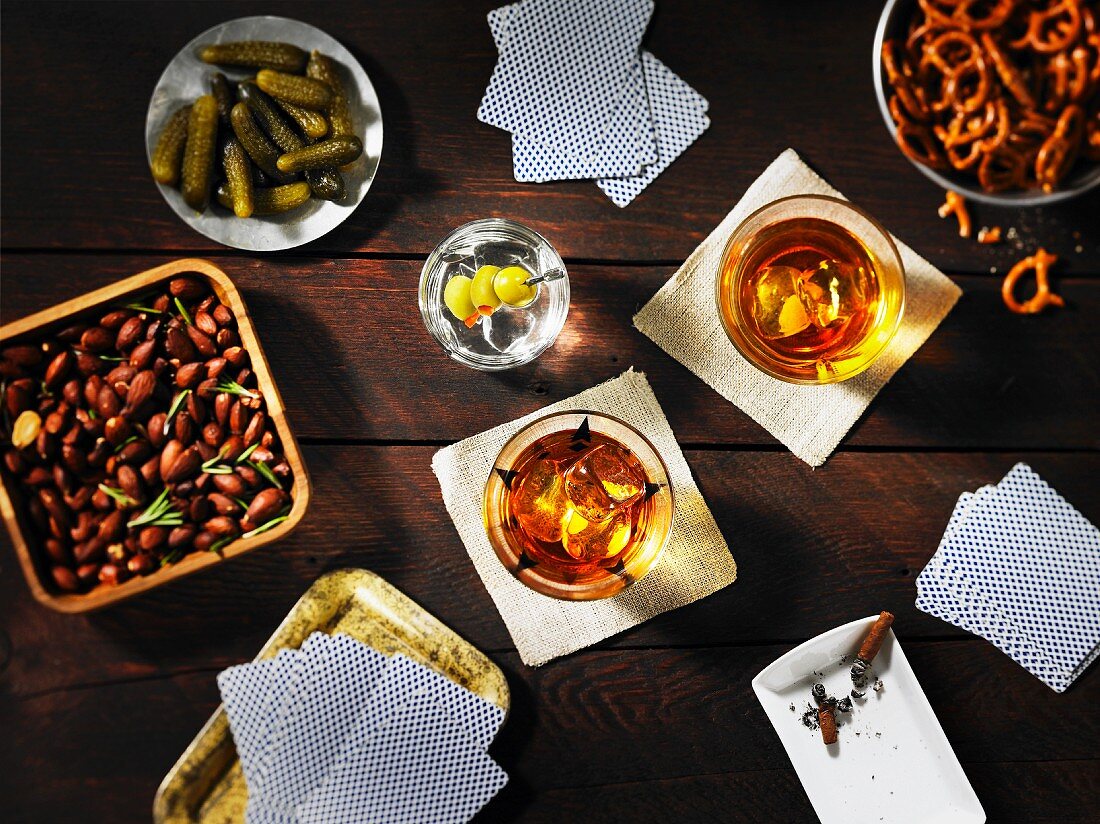 Guys night: playing cards, drinks and snacks on a table (seen from above)