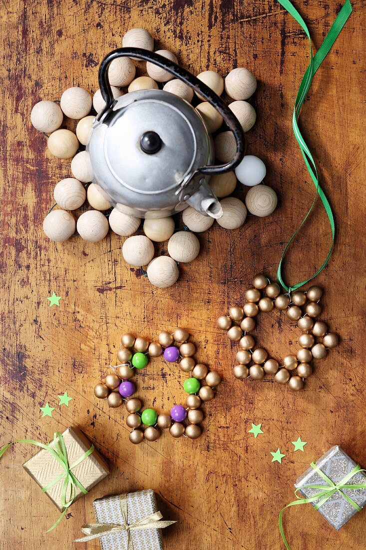Star-shaped trivets made from wooden beads on rustic wooden surface