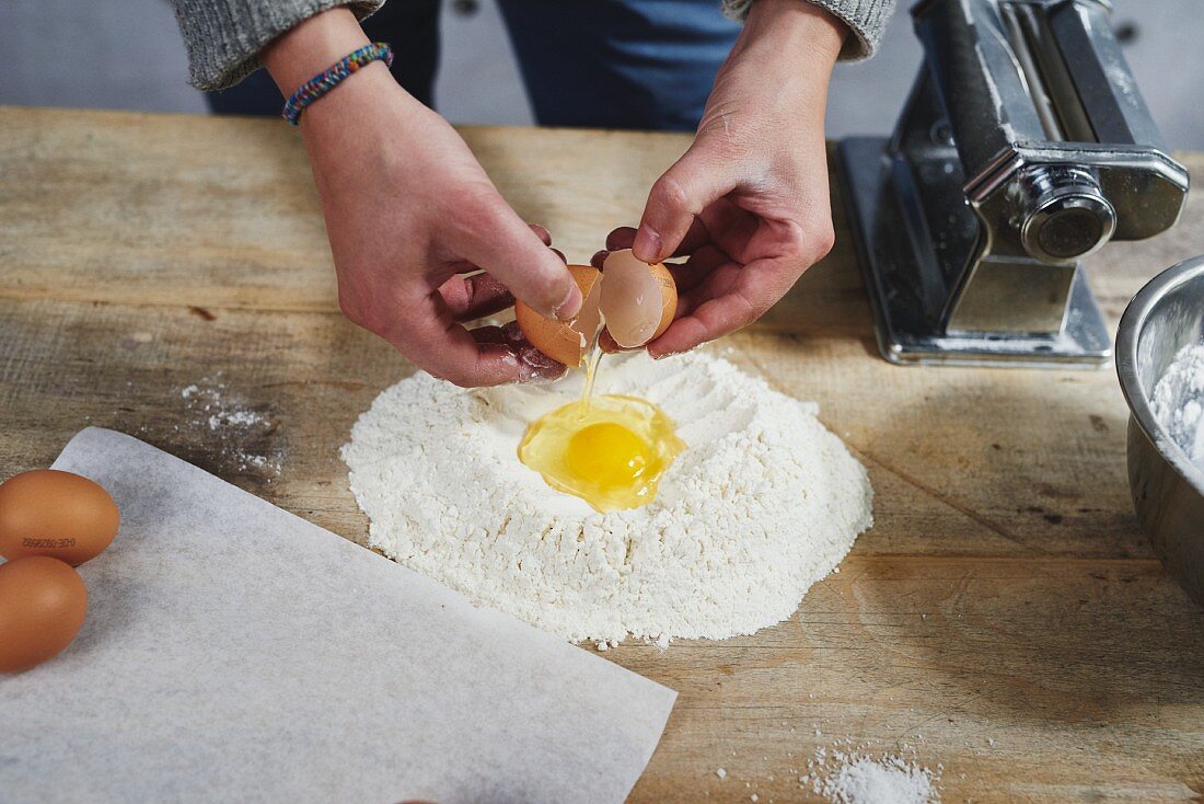 Eggs being added to flour