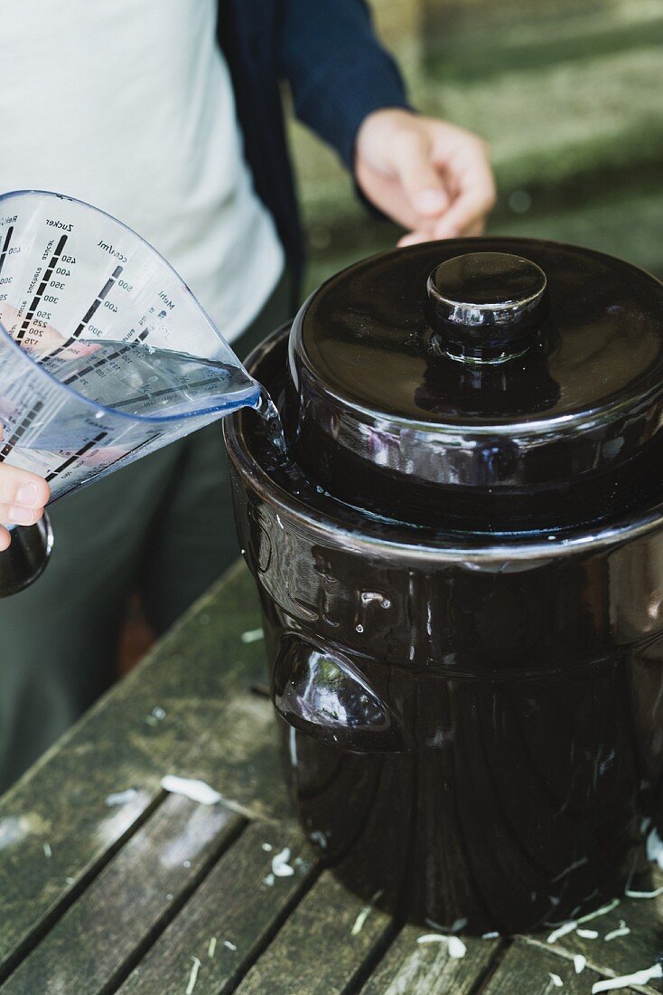 Brine being filled into the rim of a lid