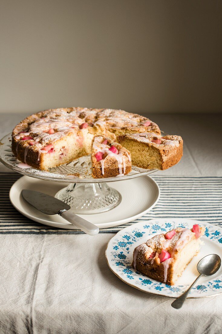 An iced cake decorated with praline roses, sliced