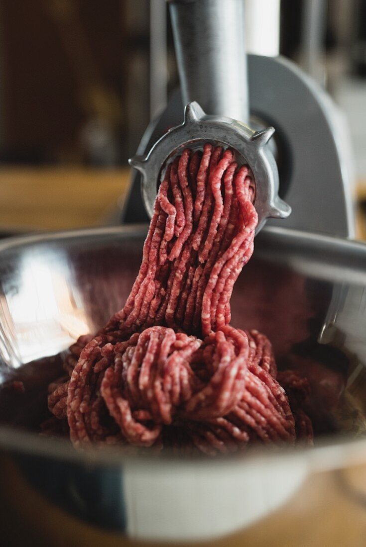 Meat coming out of a mincer