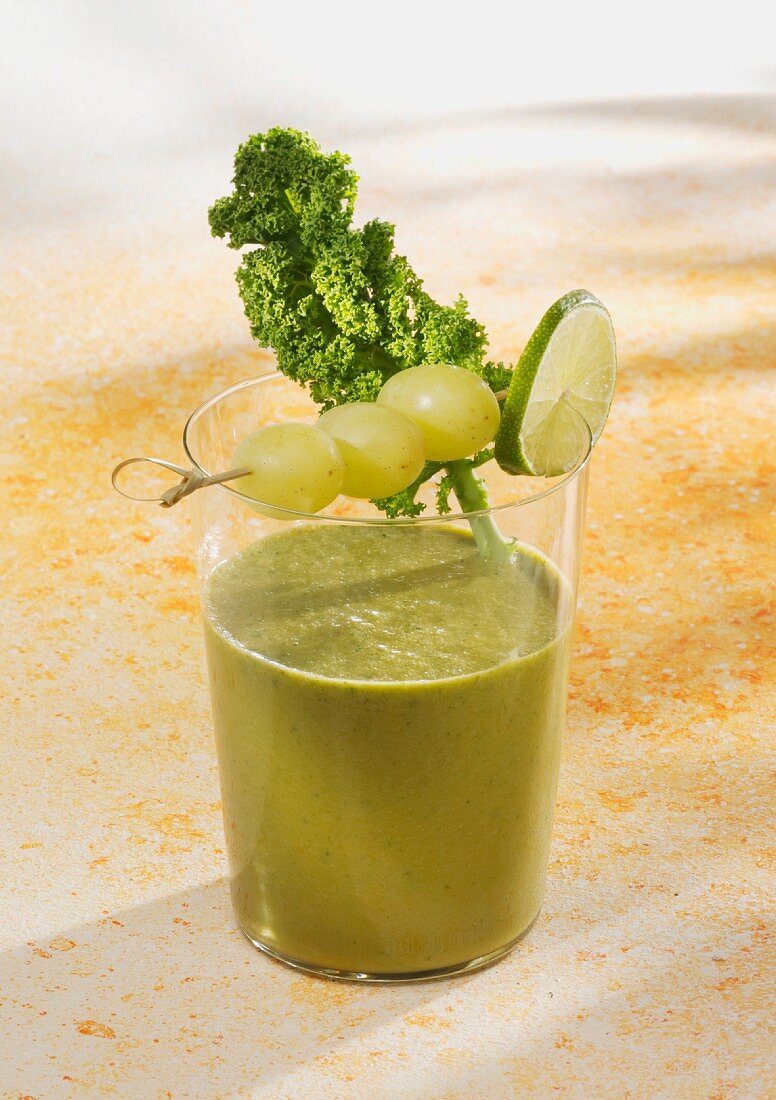 A kale and mango smoothie with grapes and apple juice