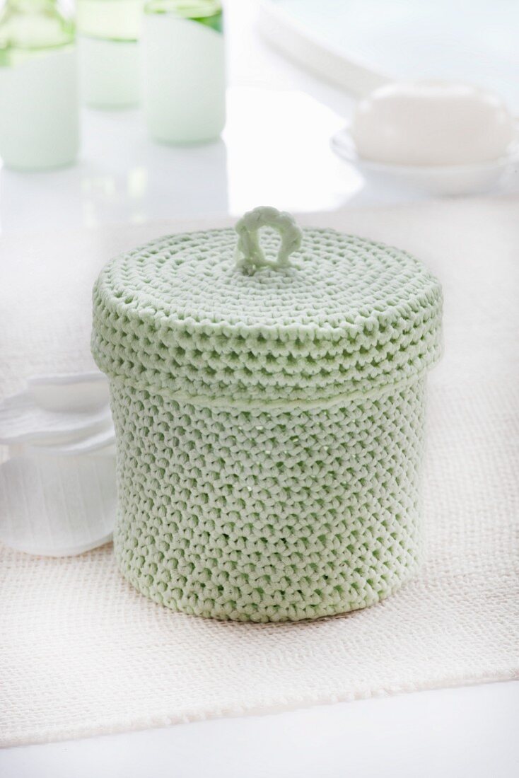 Pastel-green crocheted basket with lid