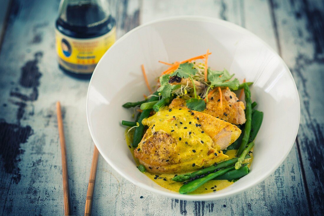 Curried chicken on green vegetables (Vietnam)