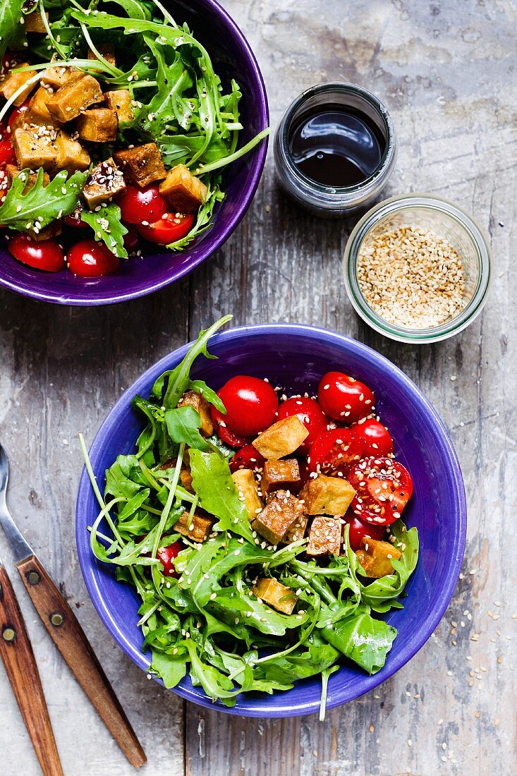 Rocket salad with sesame seed tofu and cherry tomatoes