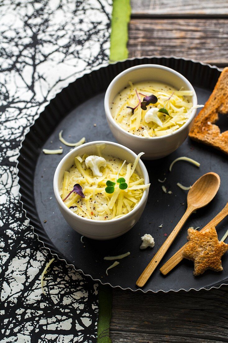 Cauliflower and potato soup with cheese, cream and white wine served with toast