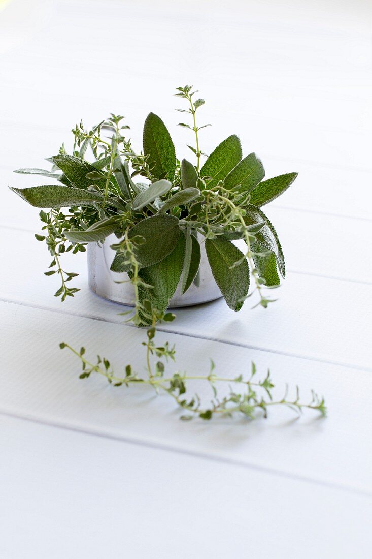 Fresh herbs (sage and thyme) in a metal pot