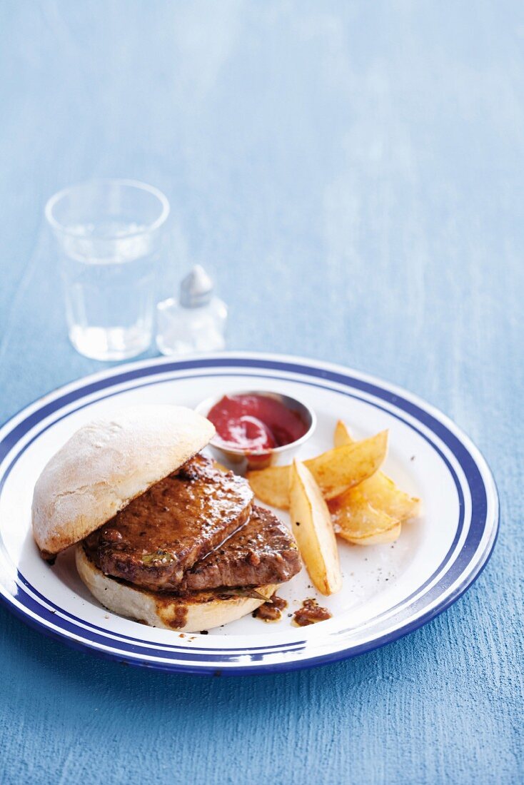 A classic prego roll (steak sandwich) with potato wedges