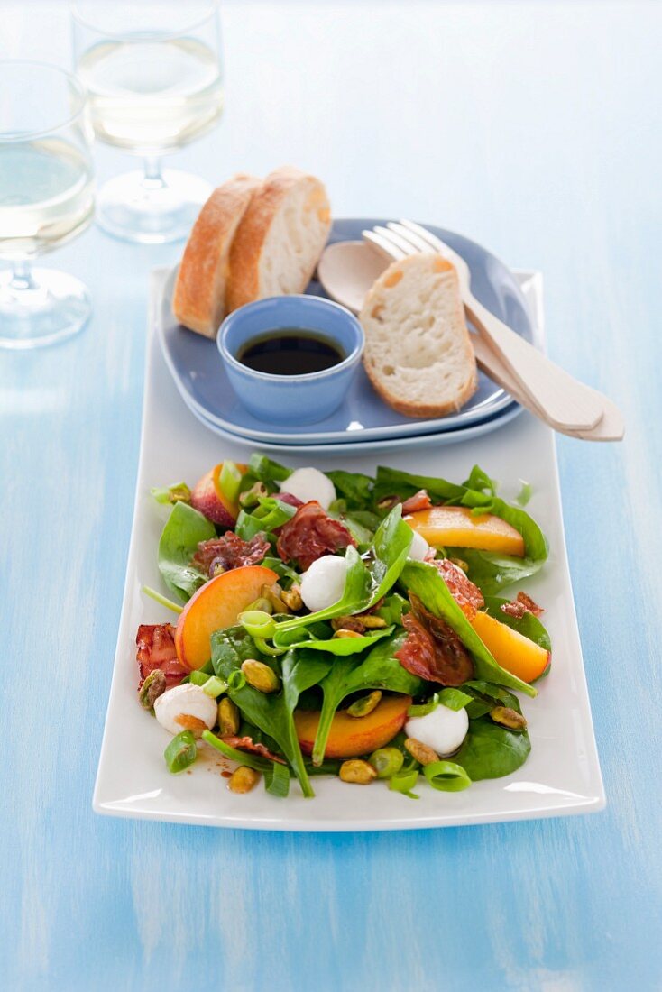 Spinach, peach and mozzarella salad with bacon