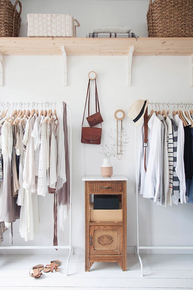 Clothes in natural shades on open clothes rails