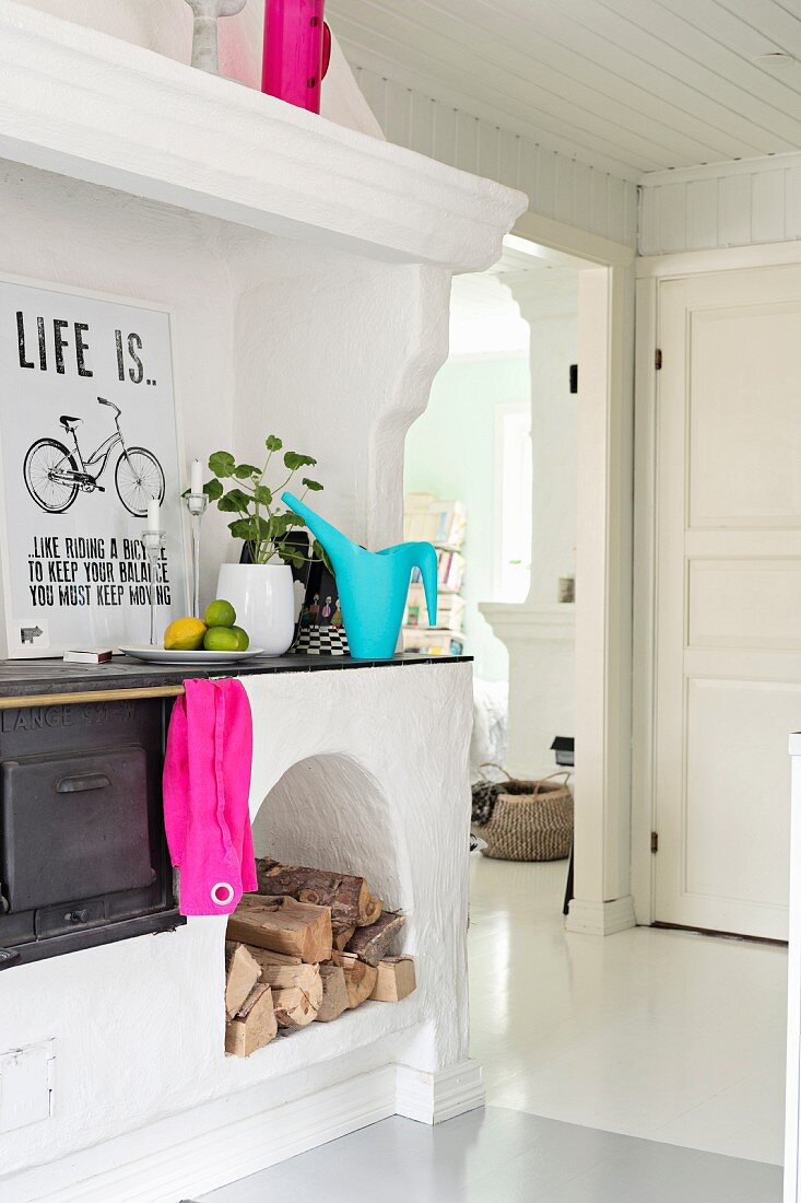 Old wood-fired cooker in white interior with splashes of bright colour