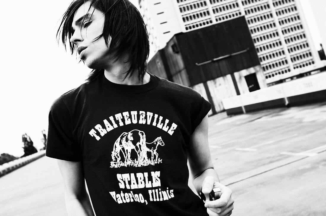 A young man wearing a printed t-shirt (black-and-white shot)