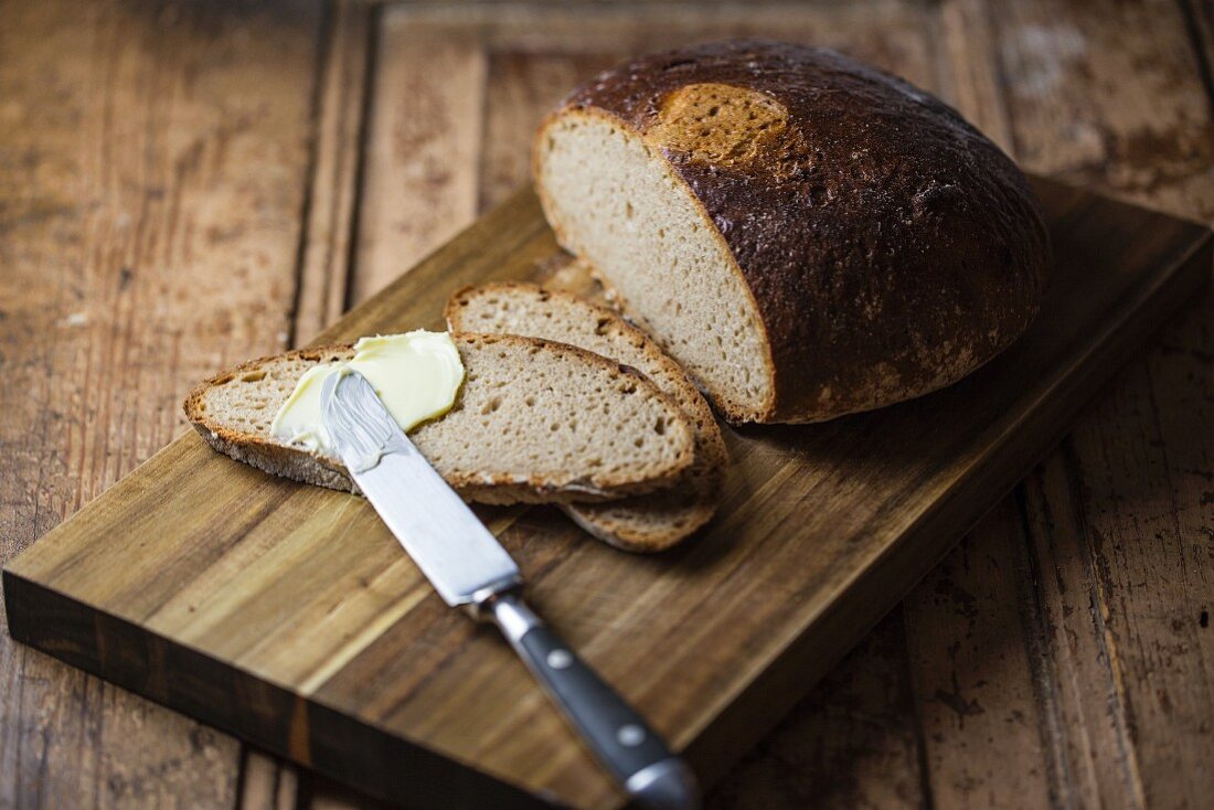 Bread being spread with butter