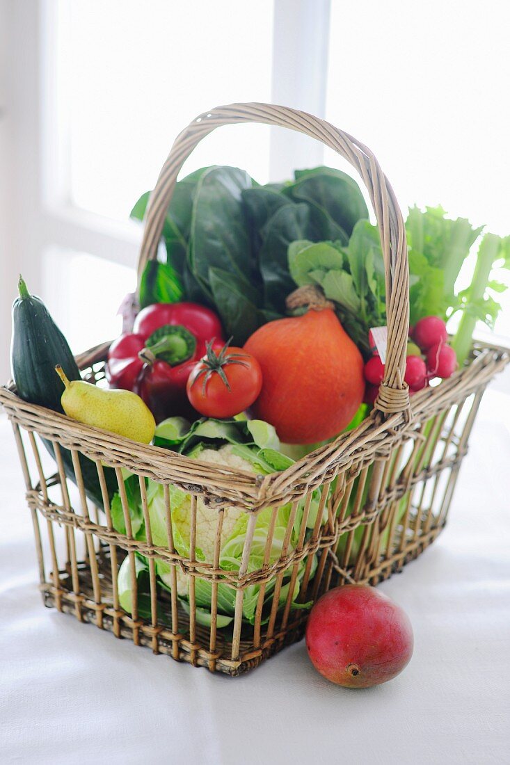 Fresh vegetables and fruit in a shopping basket