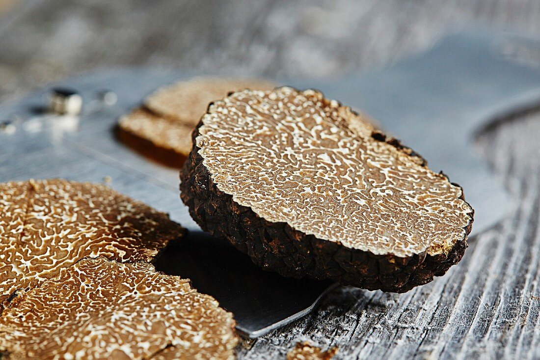 Summer or burgundy truffles (Tuber blotii) on a truffle slicer