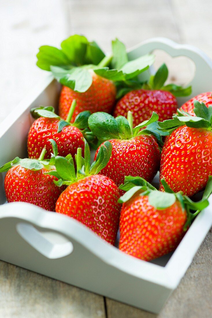 Strawberries in a white wooden tray
