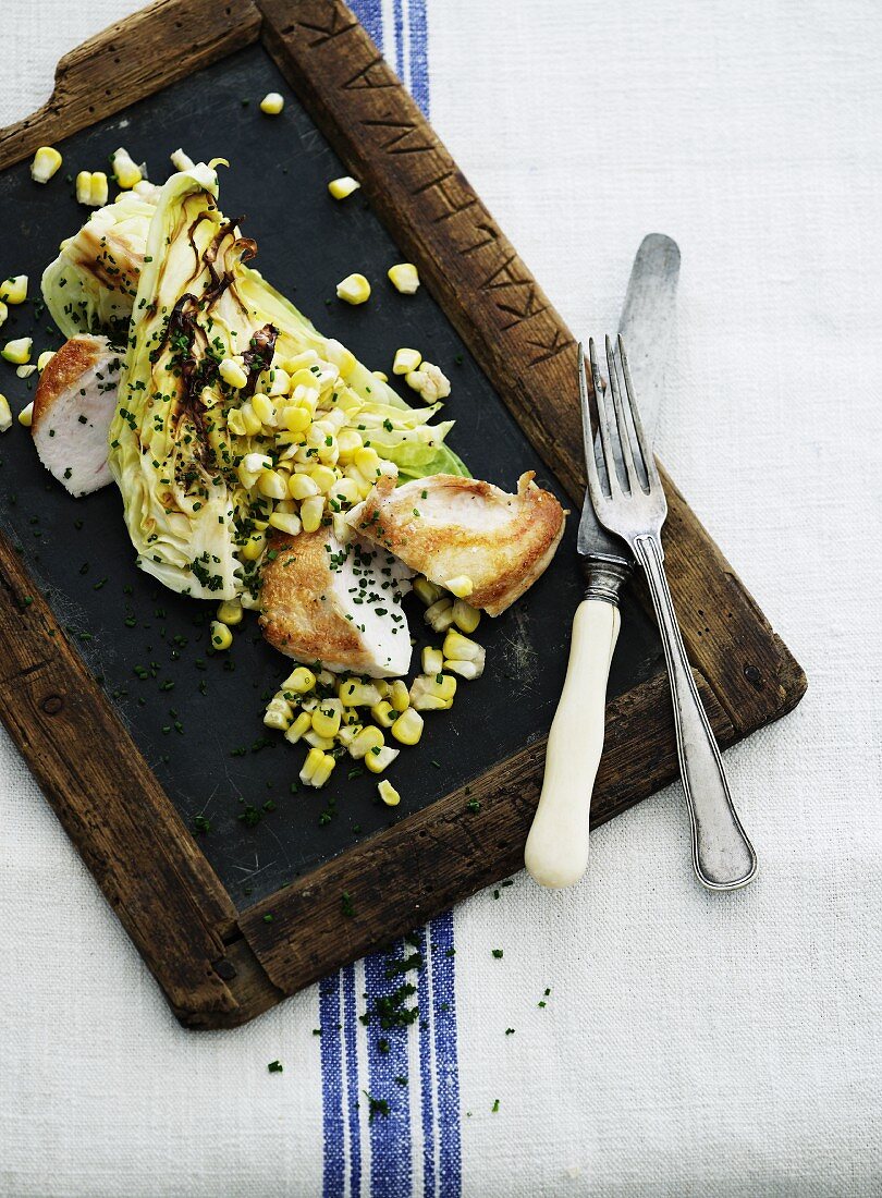 Chicken breast with fried pointed cabbage and sweetcorn