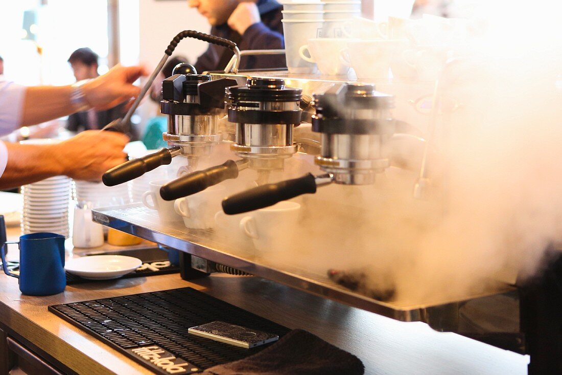 A man making an espresso in Balthasar, Vienna, Austria