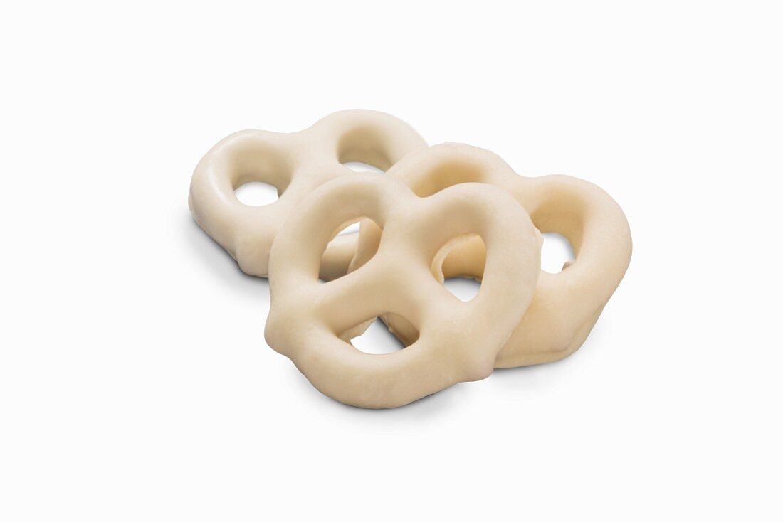 Three mini white chocolate pretzels (close-up)