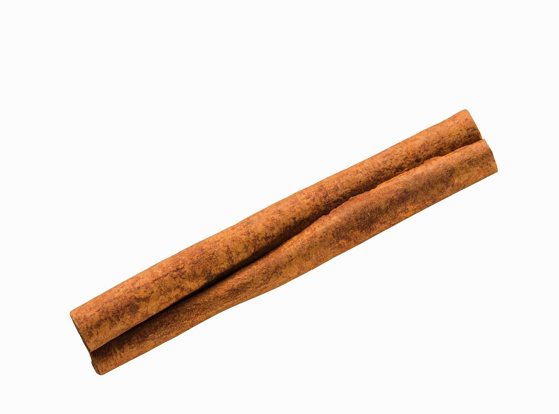 A cinnamon stick on a white surface