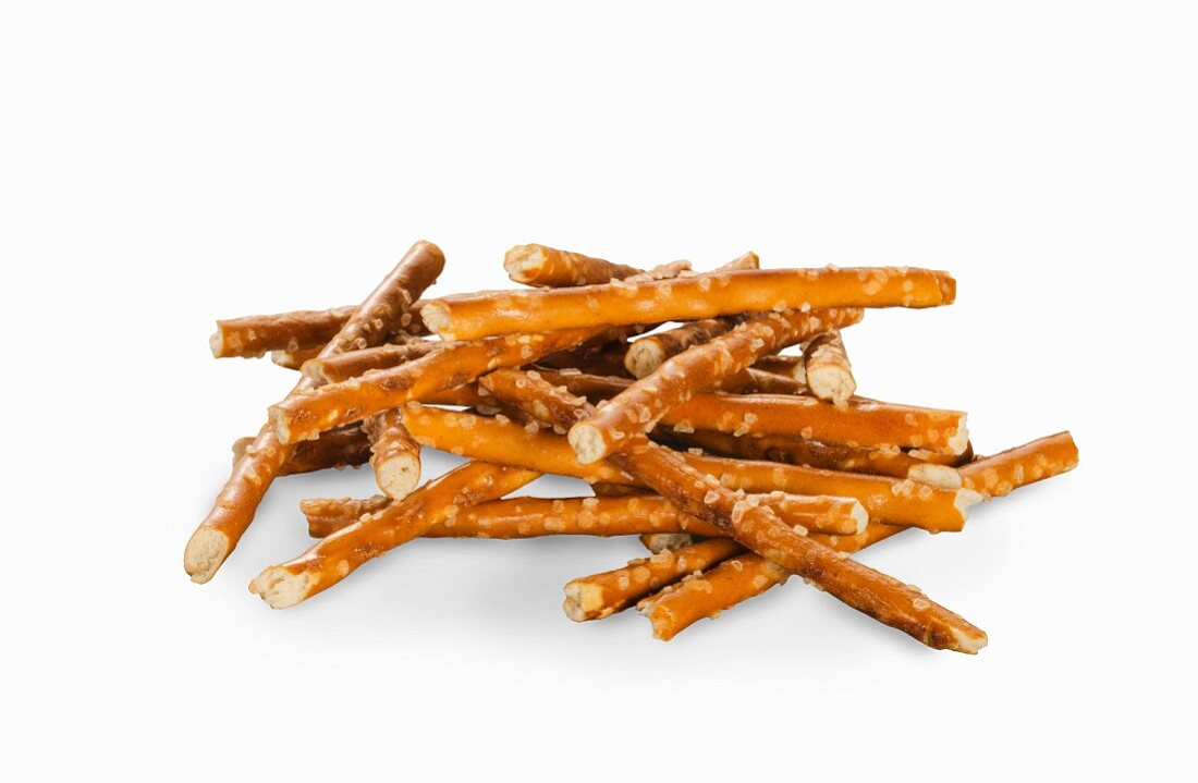 A pile of pretzel sticks on a white surface