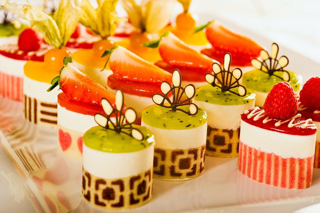 Various petit fours with strawberries and exotic fruits