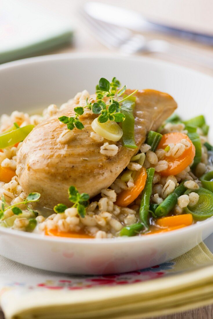 Chicken breast on a bed of vegetable barley