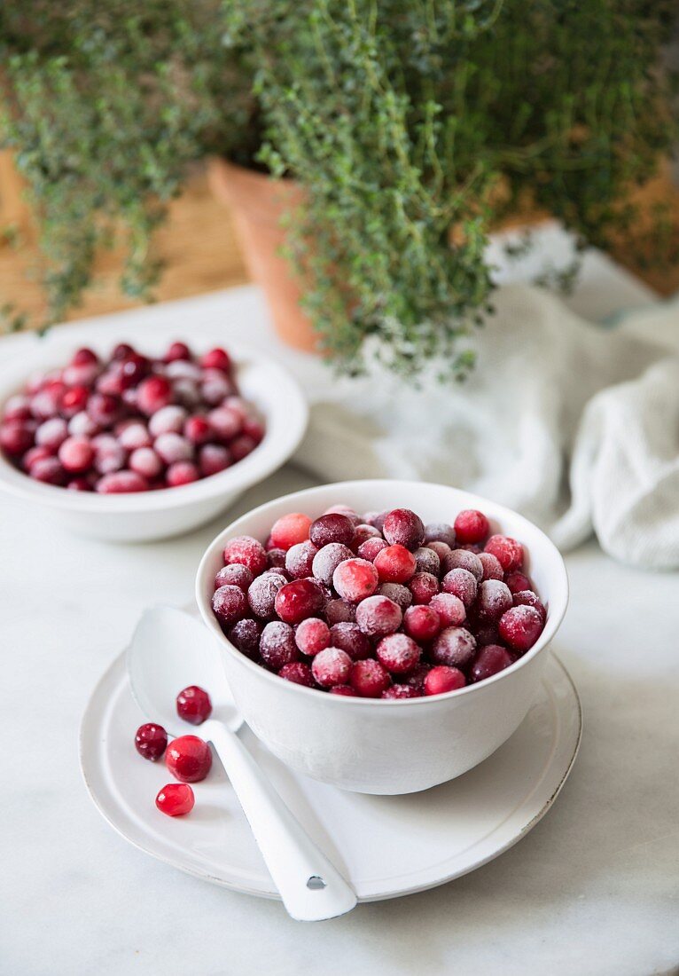 Frozen cranberries in white bowls