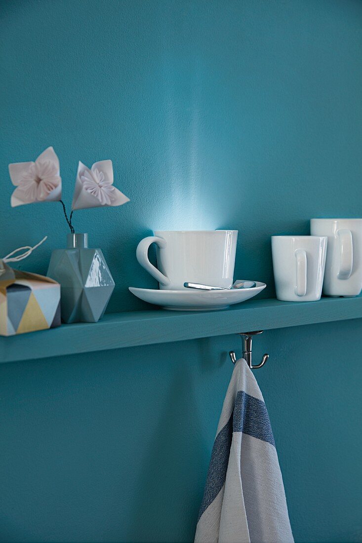 A cup with an LED light on a shelf