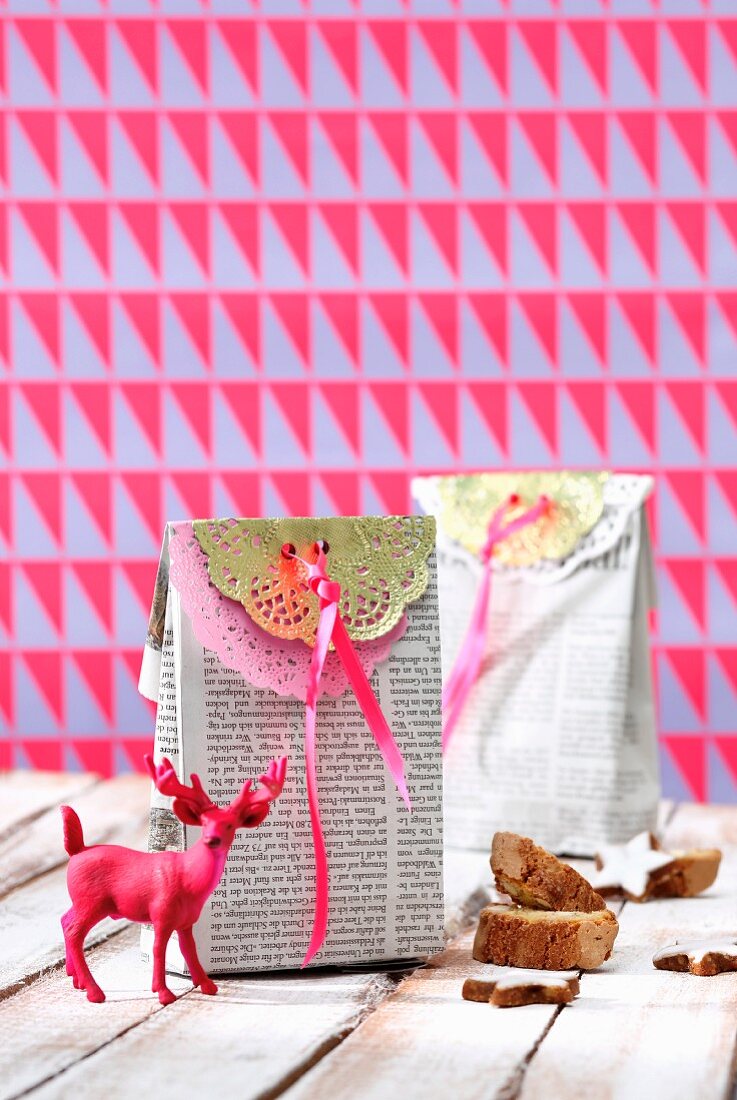 Miniature stag in front of gift bag made from newspaper