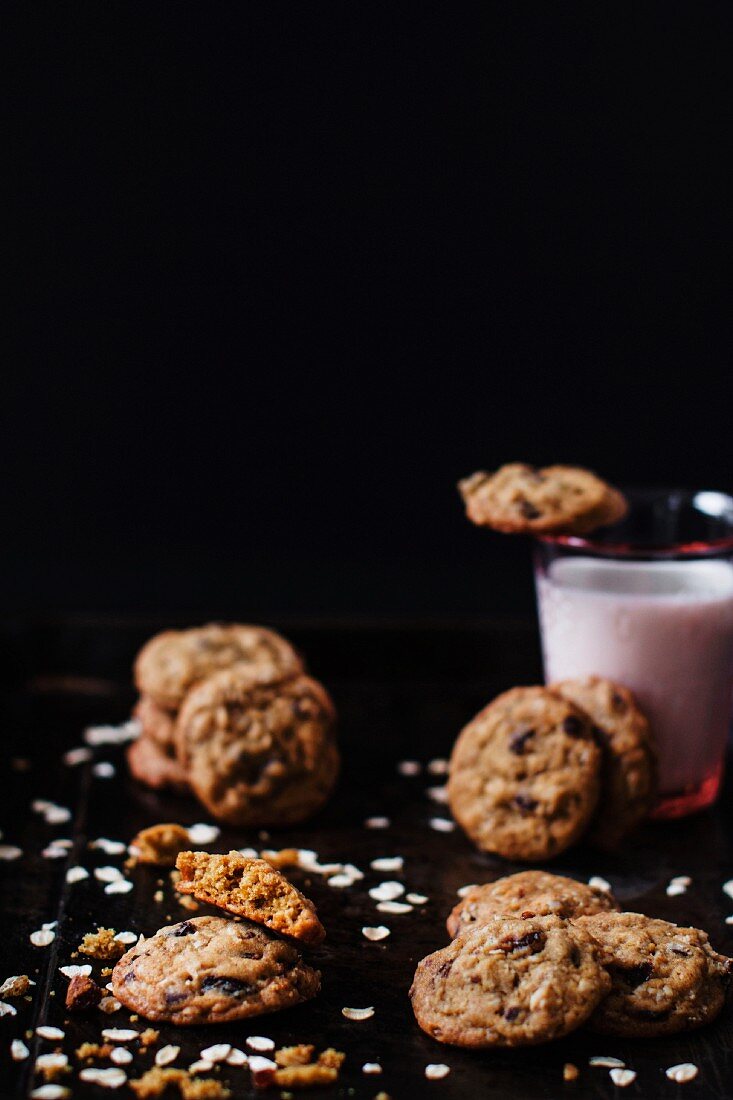 Oat cookies with raisins and chocolate chips served with a glass of milk