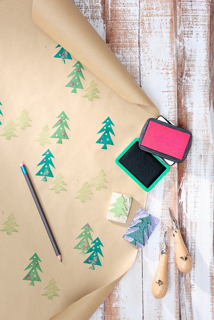 Hand-crafted wrapping paper made from brown paper printed with pattern of Christmas trees