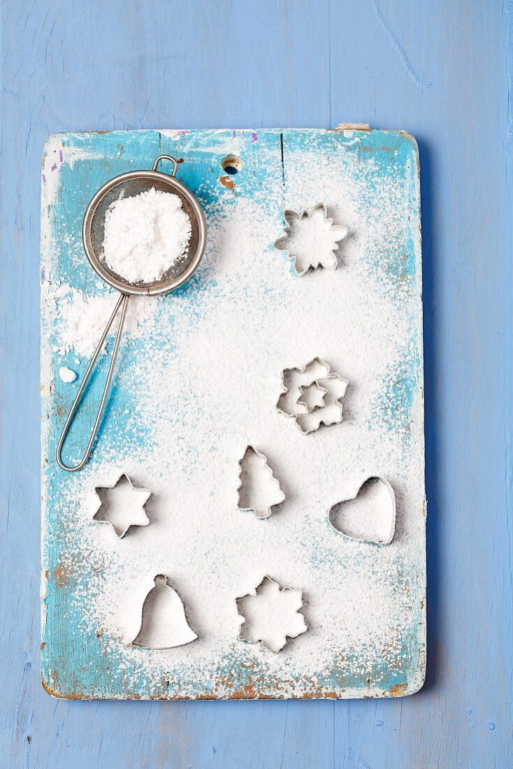 Christmas cutters and a sieve with icing sugar