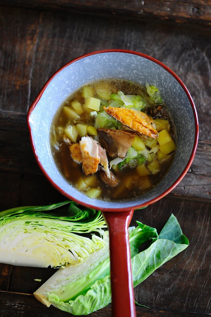 Cabbage soup with potatoes and smoked fish