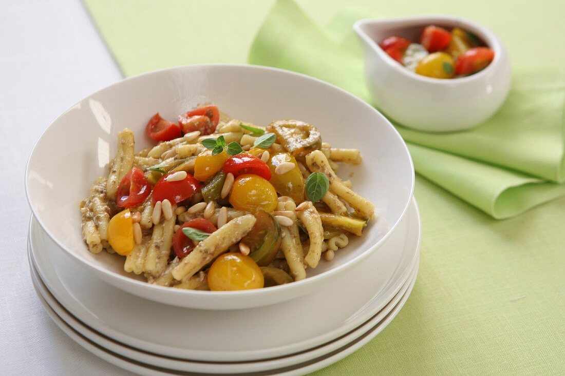 Pasta with colourful tomatoes, pine nuts and fresh oregano