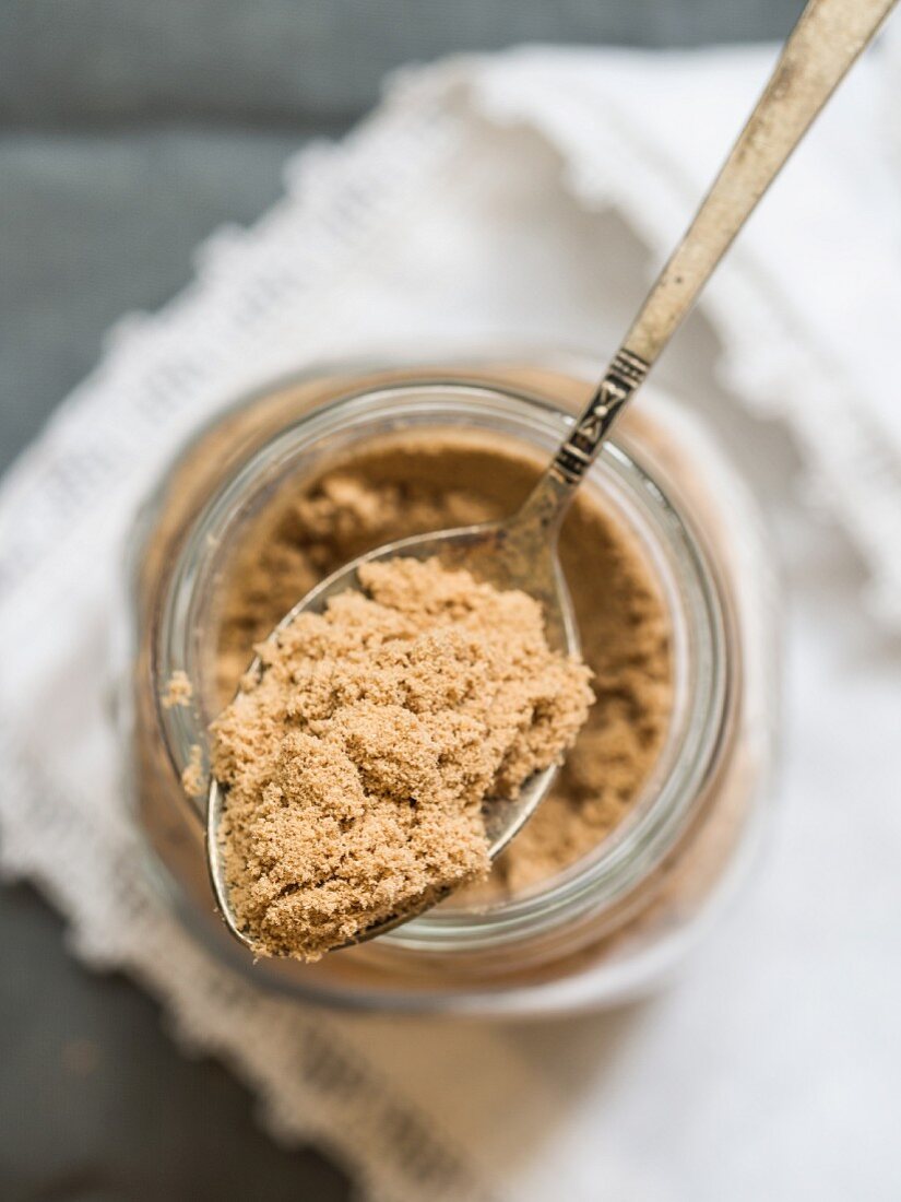 Organic African baobab powder in a jar and on a spoon