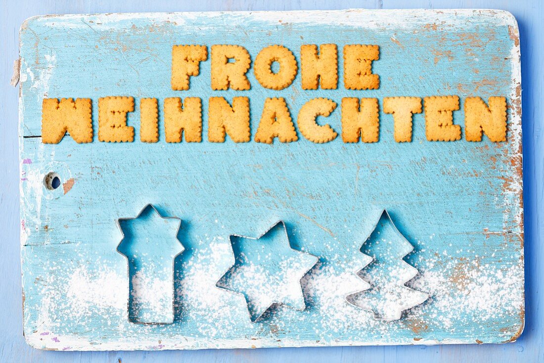 Christmas greetings written with biscuits in German and cutters