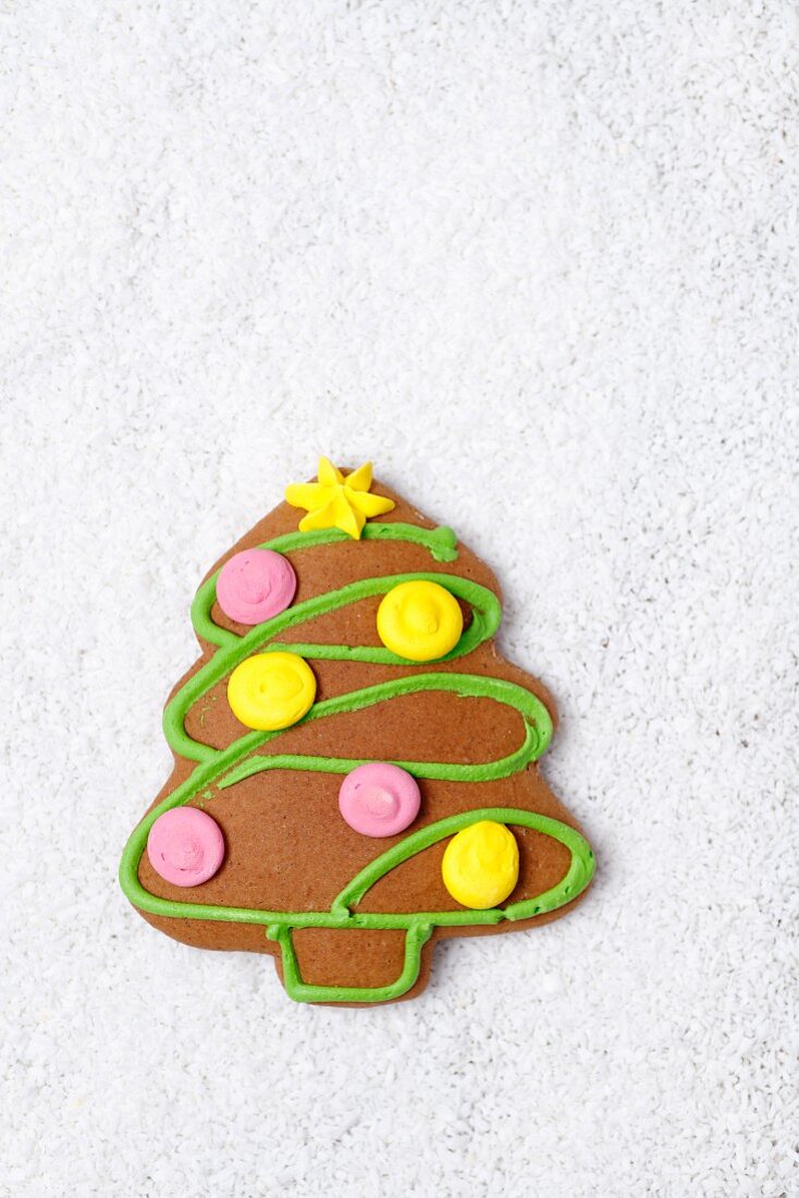 A gingerbread Christmas tree on grated coconut