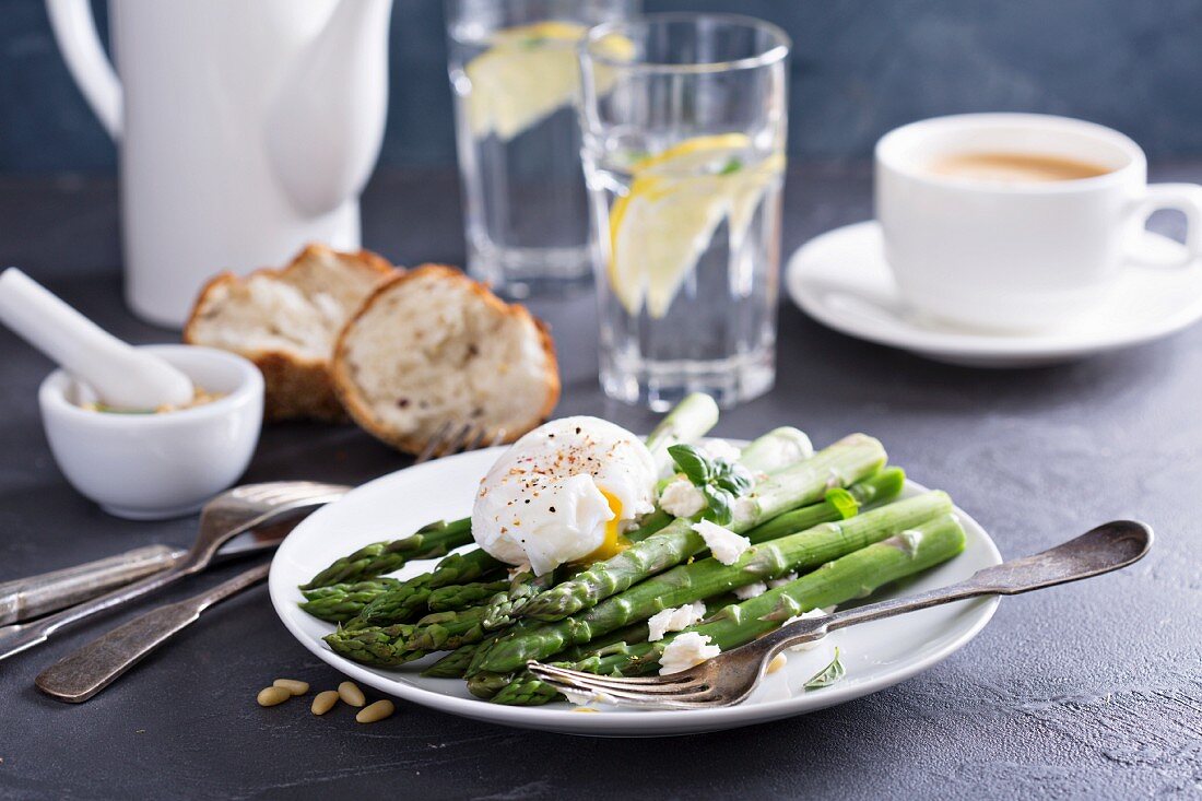 Poached asparagus with feta cheese, pine nuts and a poached egg