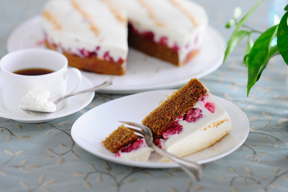 Raspberry and sour cream cake served with a cup of coffee