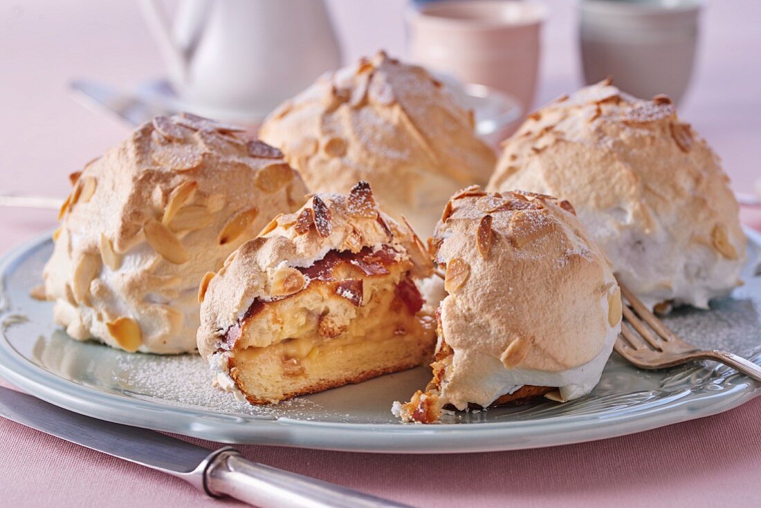 Brioche with meringue and flaked almonds, one sliced