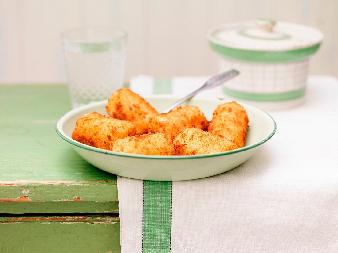 Potato croquettes on a lime-green, ceramic plate