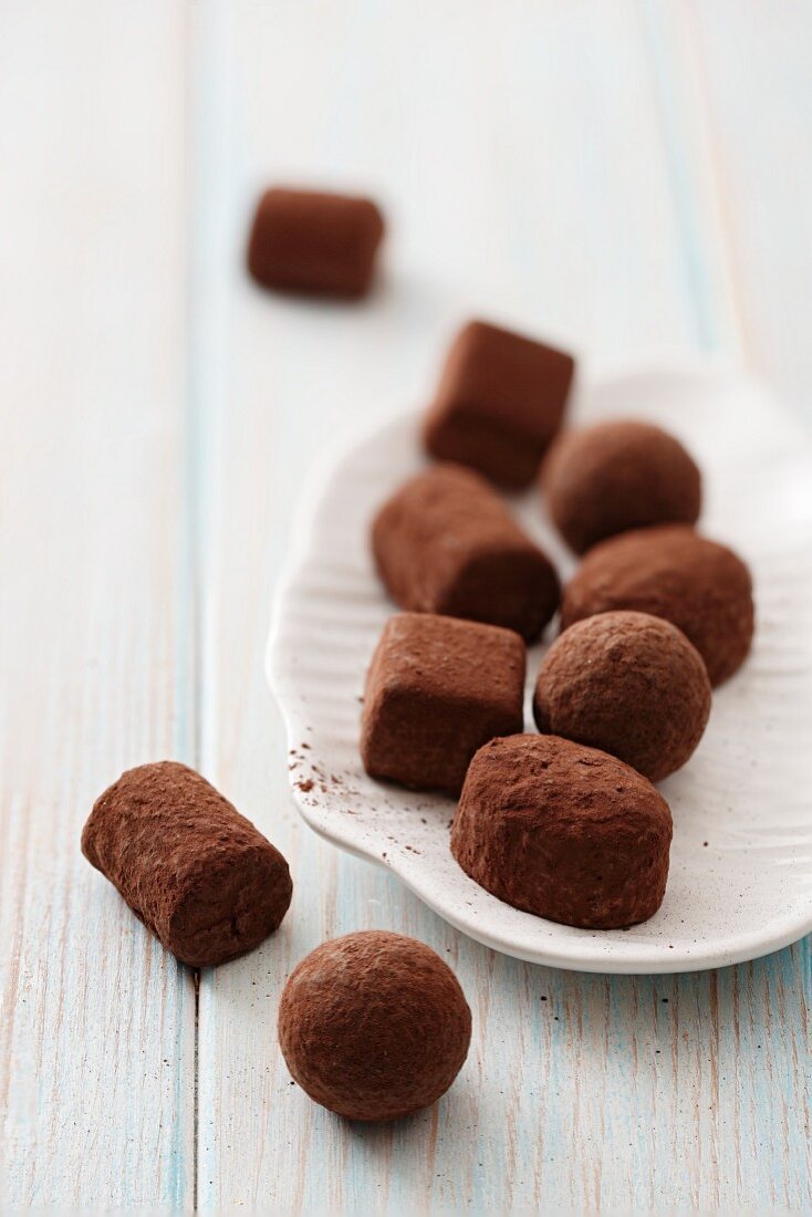 Chocolate truffles on a plate and next to it