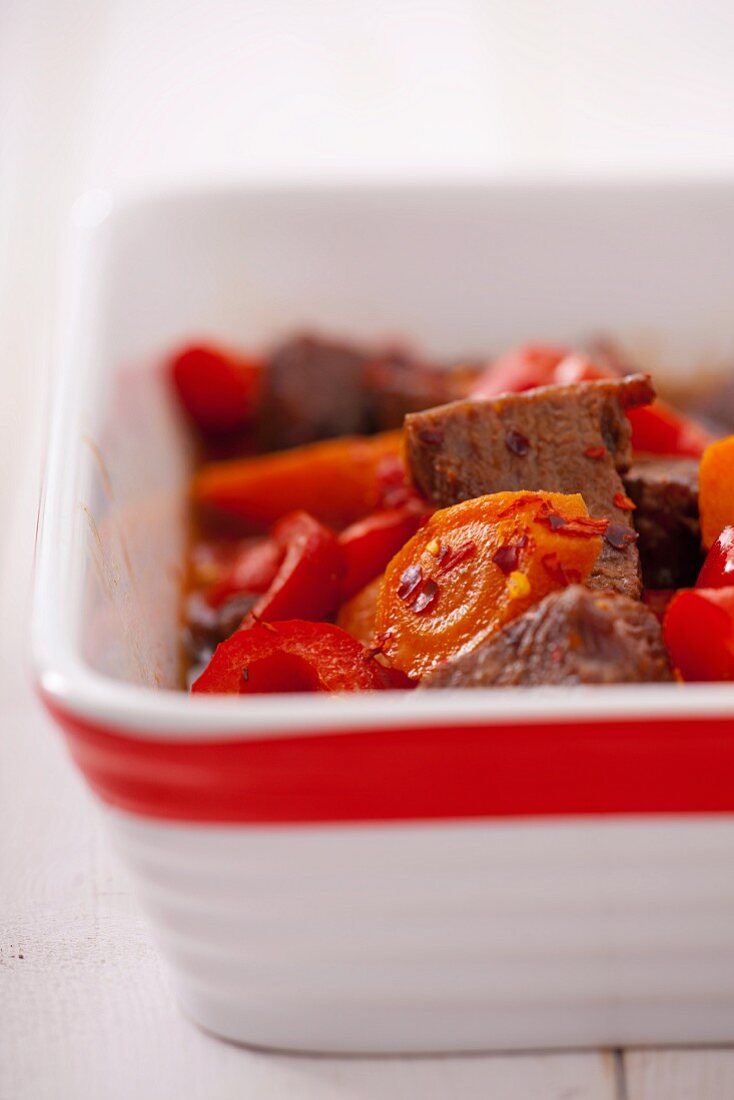 Beef with peppers and chilli flakes in a baking dish