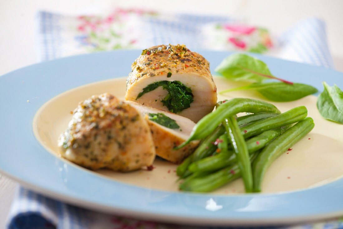 Chicken breasts filled with spinach served with green beans