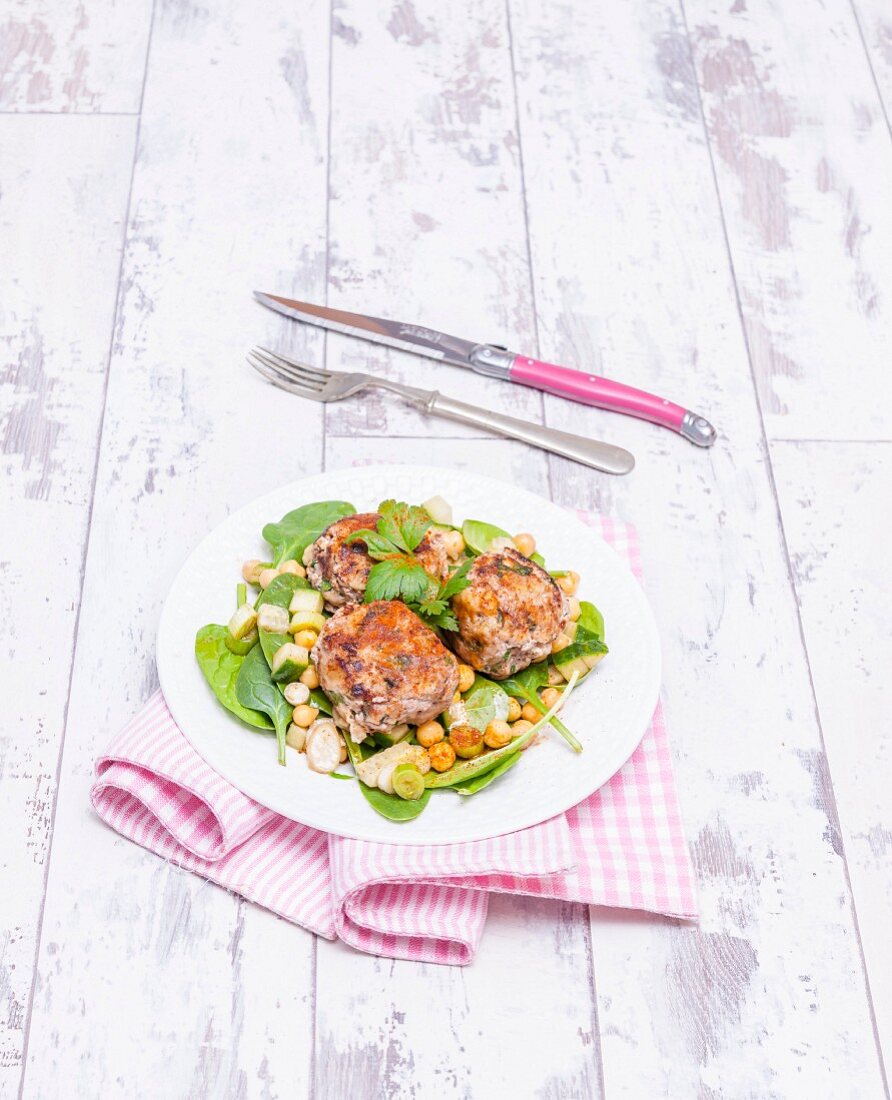 Moroccan lamb meatballs with pine nuts on a bed of salad